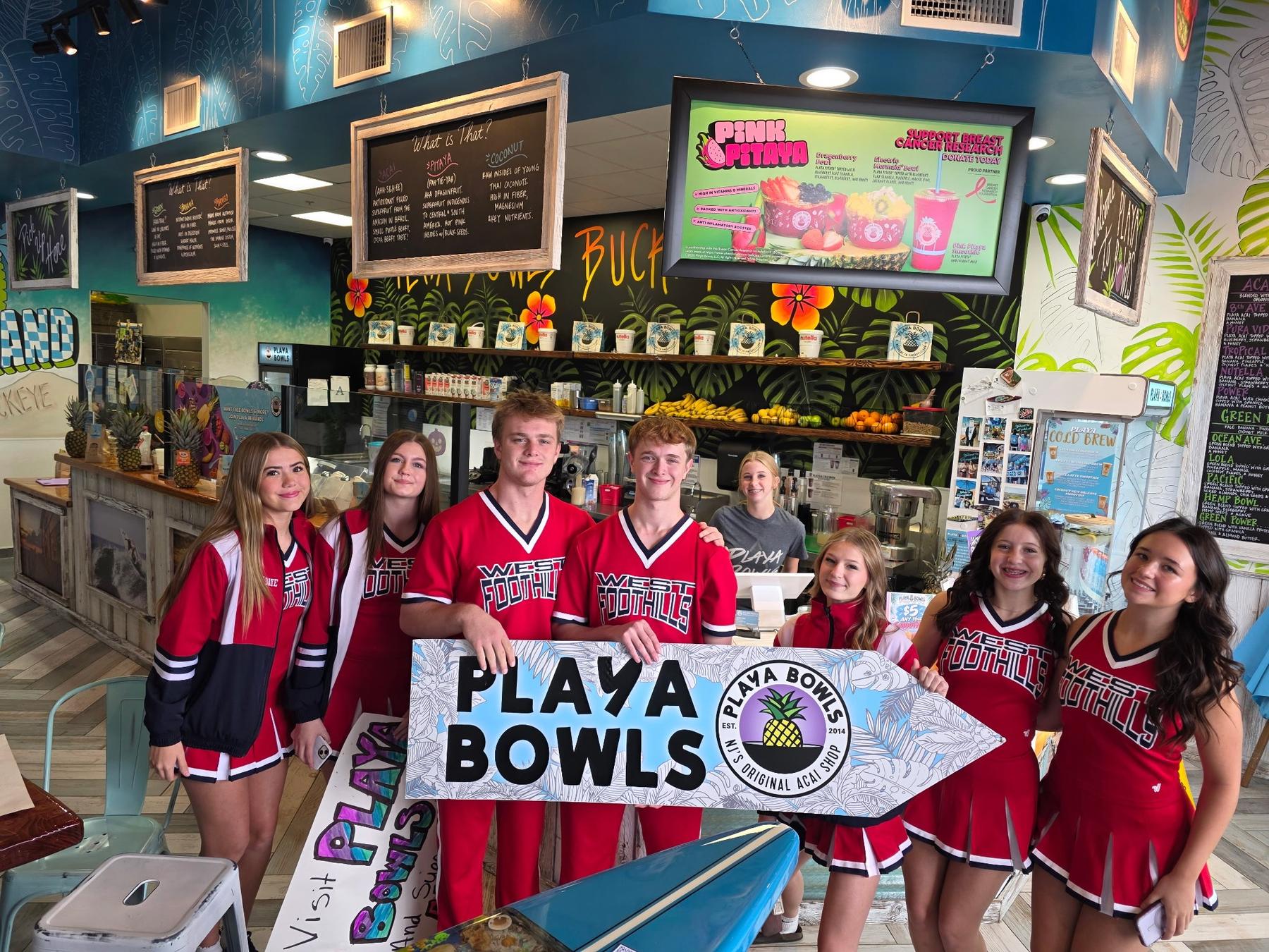 ALA cheer and football at the counter on their fundraiser night