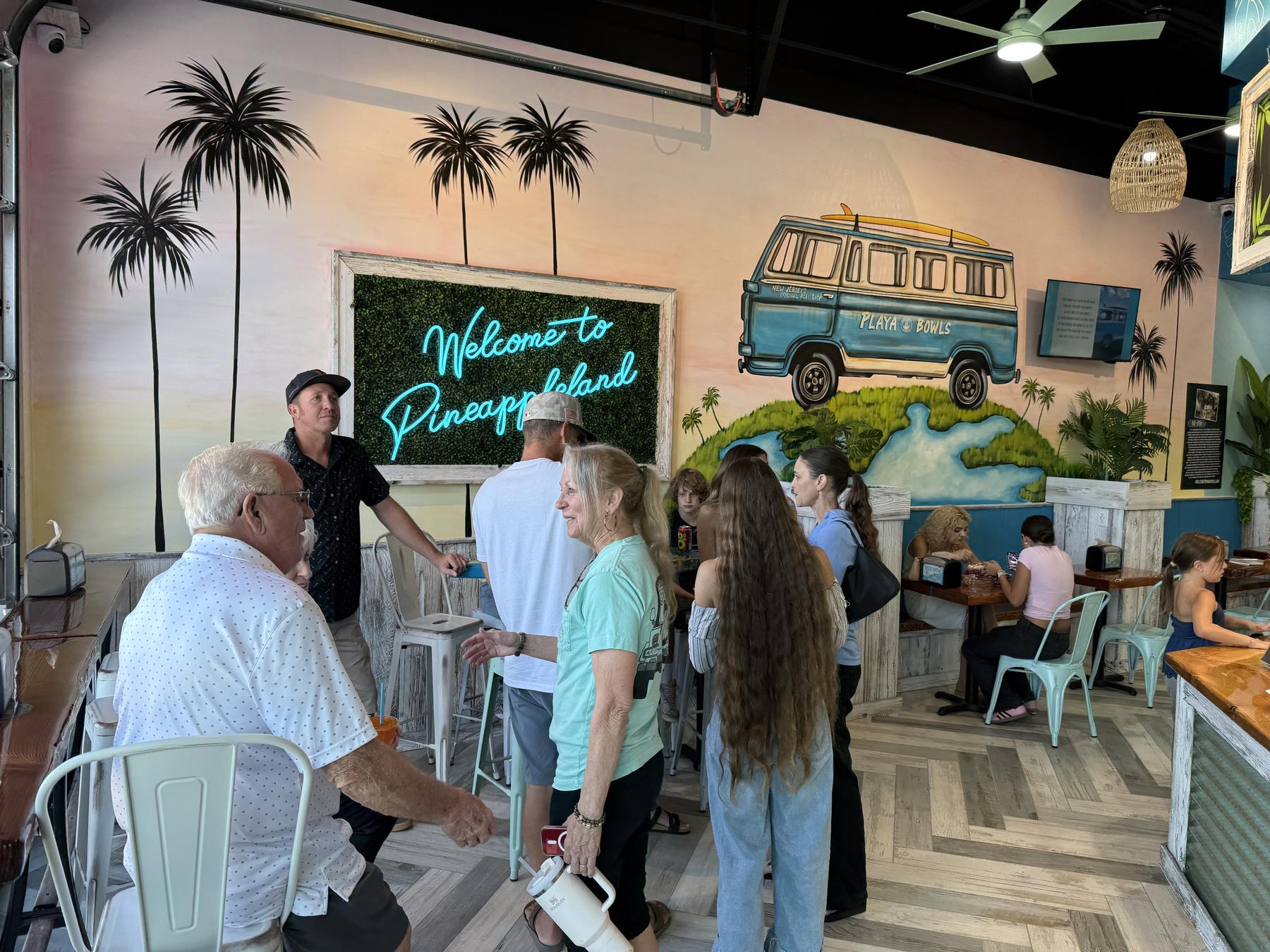 Guests under the Welcome to Pineappleland sign