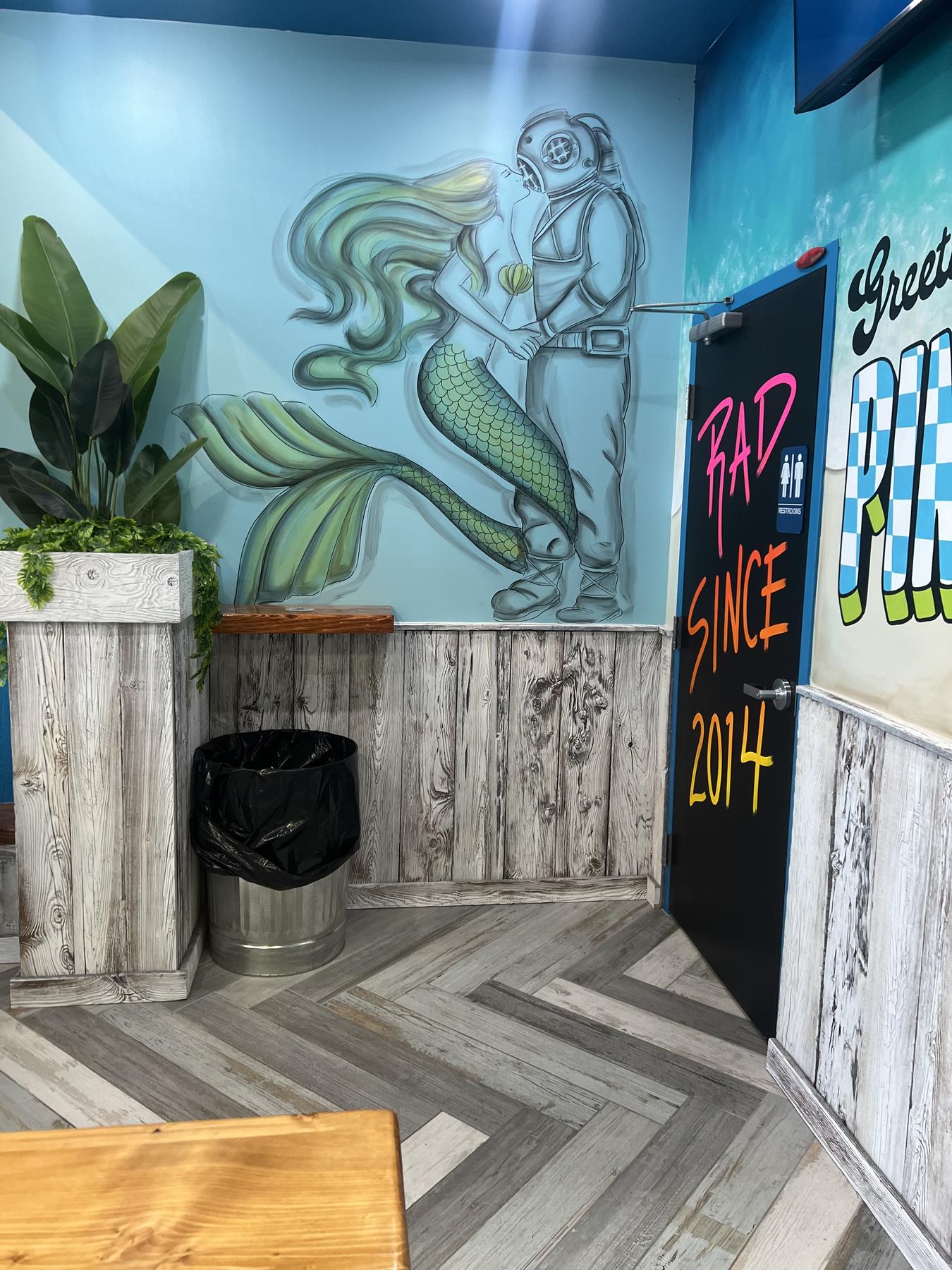 The mermaid mural by the door